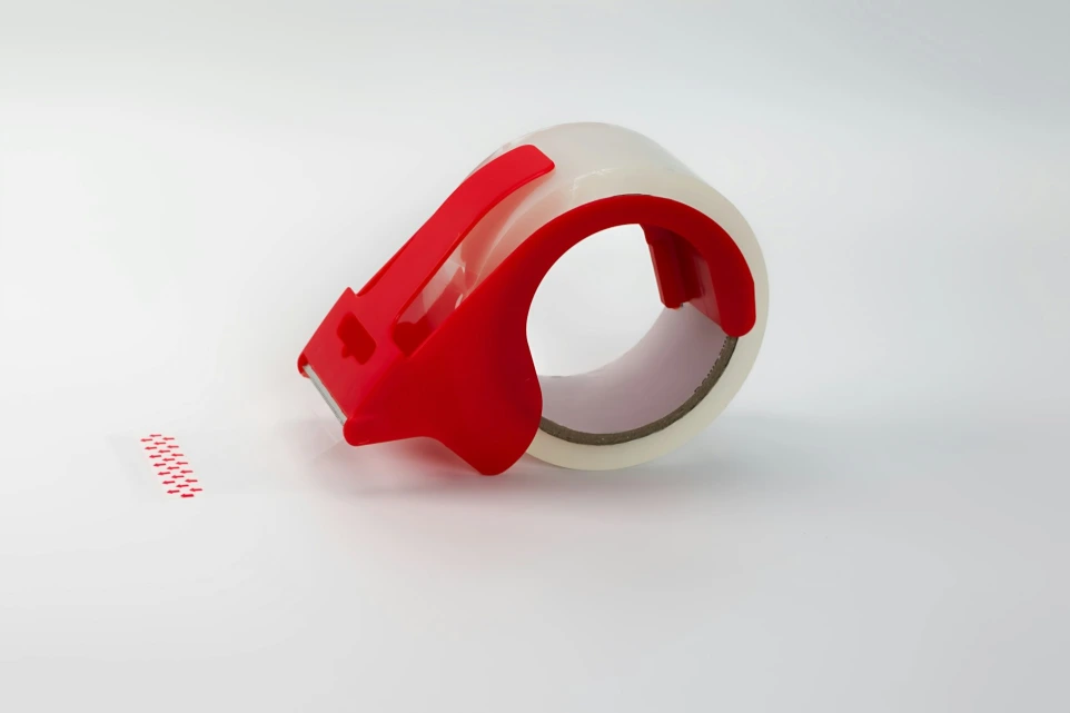 Red tape dispenser with clear packing tape